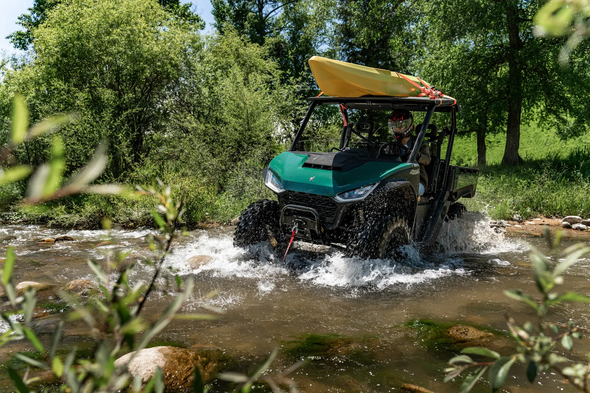Kayak on the roof, creek under the tires.